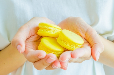Macaroon in the handの写真素材