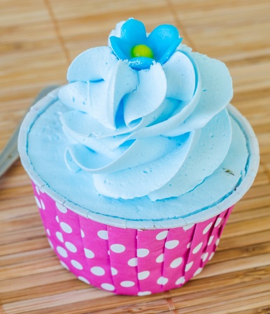 Mint cupcake on bamboo table with white tea cup&tea potの写真素材