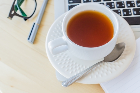 white cup tea&laptop on the wood tableの写真素材