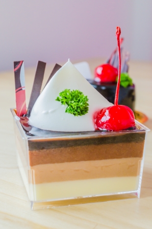 Vanilla , Chocolate , Coffee layer cake with cherry on topの写真素材