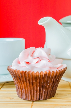 Pink cupcake on the table with colorful backgroundの写真素材