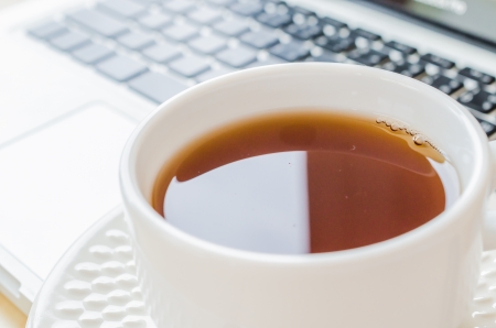 white cup tea&laptop on the wood tableの写真素材