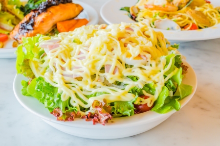 Salad in white bowl on the tableの写真素材