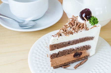 Chocolate cake with black cherry in white dish