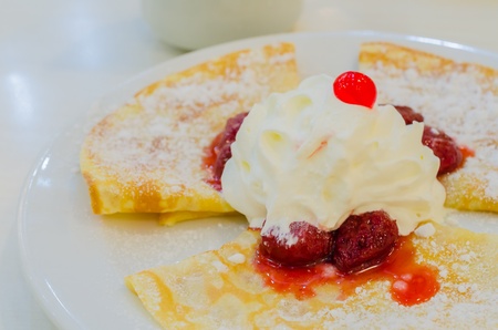 Pancake with cream&strawberry on topの写真素材
