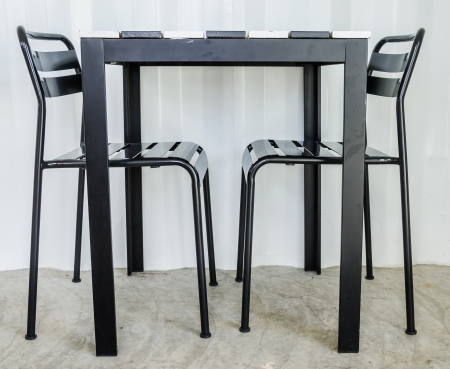 Black metal chair on gray wallの写真素材