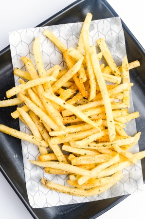 Top of view French fried in black dish on white backgroundの写真素材