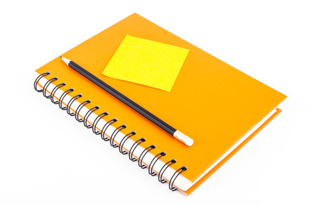 Note pad on notebook and pencil on isolated white background