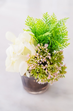 Fake flower on the stone tableの写真素材