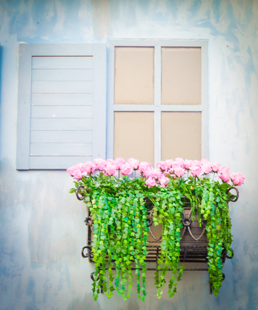 Old windows and flowers box , process in vintage style pictureの写真素材