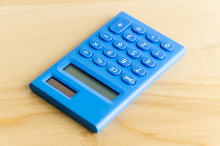 Calculator on wood tableの写真素材