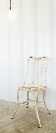 Old vintage chair on gray wallの写真素材