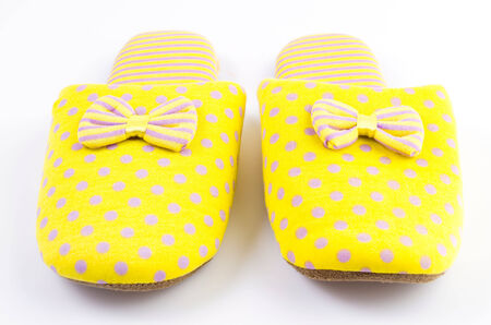 Yellow house slippers isolated on white backgroundの写真素材
