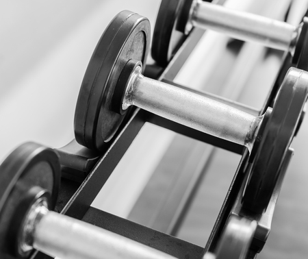 Gym equipment with close up selective focus to a dumbbellの写真素材