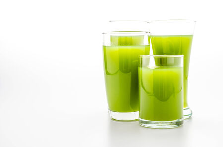 Kiwi juice glass isolated on whiteの写真素材
