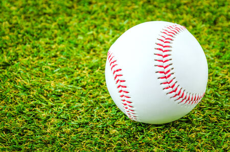 Baseball on green grassの写真素材