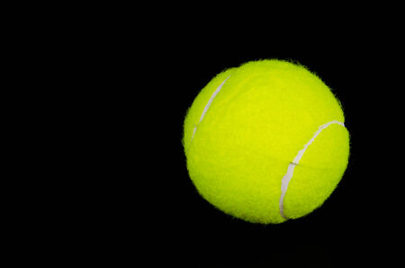 Tennis ball on black backgroundの写真素材