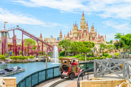 SINGAPORE - JUNE 25: Tourists and theme park visitors taking pictures of the large rotating globe fountain in front of Universal Studios on JUNE 25, 2014 in Sentosa island, Singaporeのeditorial素材