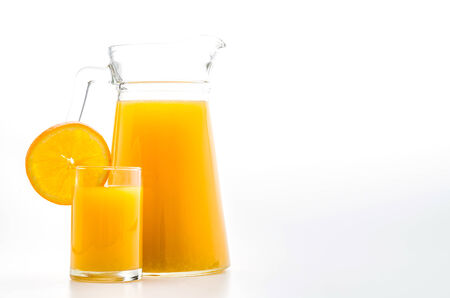 Orange juice glass isolated on whiteの写真素材