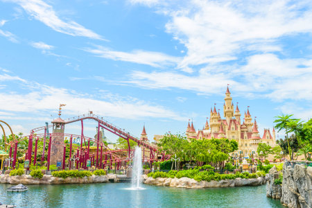 SINGAPORE - JUNE 25: Tourists and theme park visitors taking pictures of the large rotating globe fountain in front of Universal Studios on JUNE 25, 2014 in Sentosa island, Singaporeのeditorial素材