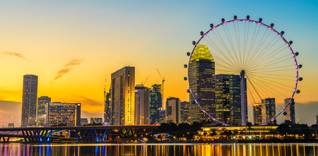 Singapore - June 23, 2014: View from distance to Singapore Flyer, huge ferries wheel and famous hotel and casino at Bayfront of Singapore. is round about 200 meters high and 340 meters wide.のeditorial素材