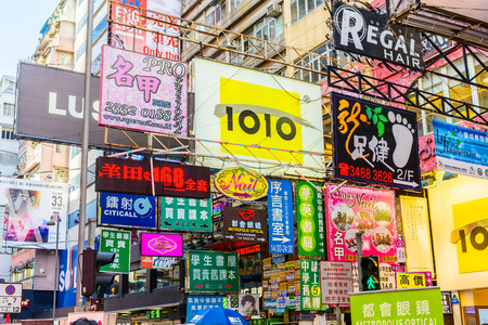 HONG KONG, CHINA - APR 10: Crowded street view on April 10, 2014 in Hong Kong, China. With 7M population and land mass of 1104 sq km, it is one of the most dense areas in the world.のeditorial素材