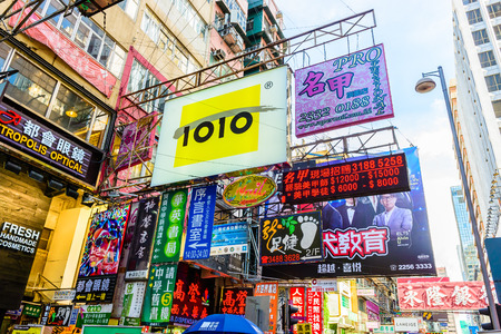 HONG KONG, CHINA - APR 10: Crowded street view on April 10, 2014 in Hong Kong, China. With 7M population and land mass of 1104 sq km, it is one of the most dense areas in the world.のeditorial素材