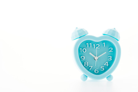 blue alarm clock isolated on white の写真素材