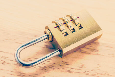 Key pad lock on wooden background process vintage style picture