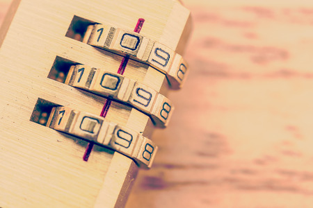 Key pad lock on wooden background process vintage style picture