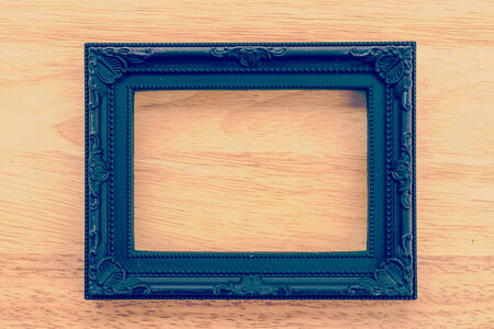 Vintage frame on wooden background process vintage style picture
