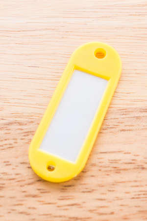 Name tag luggage on wooden backgroundの写真素材