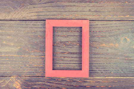 Photo frame on wooden background - vintage style effect pictureの写真素材