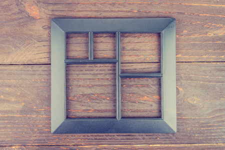 Photo frame on wooden background - vintage style effect pictureの写真素材