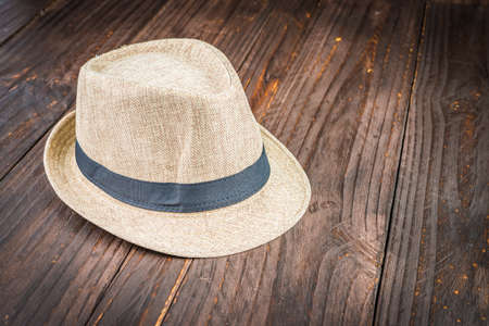 Beach hat on wooden background - vintage dark style picturesの写真素材