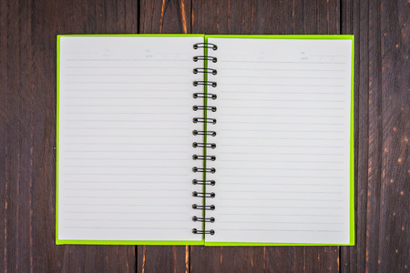 Note book on wooden background - vintage effect style picture