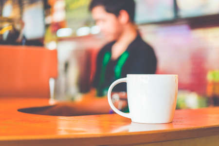 Coffee cup in coffee shop - vintage style effect pictureの写真素材