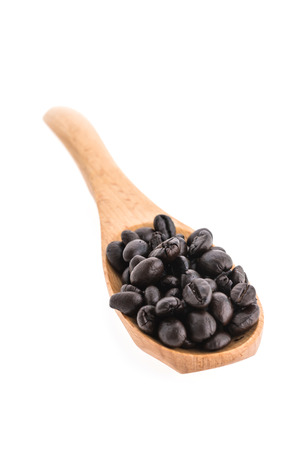 Coffee beans in wooden spoon isolated on white backgroundの写真素材