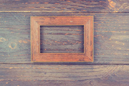 frame on wooden background - vintage style effect picture