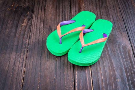 Slipper on wooden background - vintage effect style picturesの写真素材