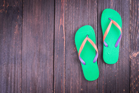 Slipper on wooden background - vintage effect style picturesの写真素材