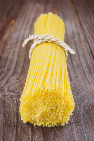 Pasta on wooden background - vintage effect style picturesの写真素材