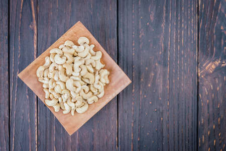 Cashew on wooden background - film effect style picturesの写真素材