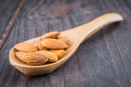 Almond on wooden background - vintage old effect stlye picturesの写真素材