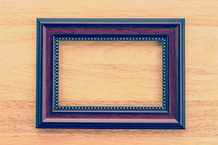 Vintage frame on wooden background process vintage style pictureの写真素材