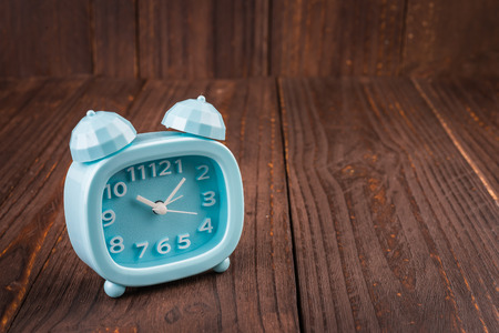 Clock on wood backgroundの写真素材