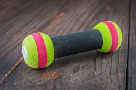 dumbbell on wood background