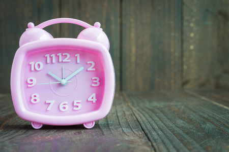 Clock on wood backgroundの写真素材