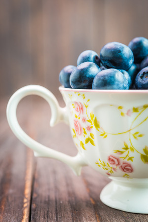 Blueberry cup on wooden background - vintage effect style picturesの写真素材
