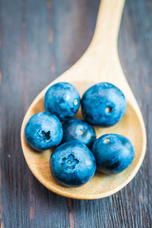 Blueberry spoon on wooden background - vintage effect style picturesの写真素材